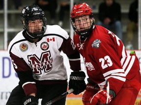 Chatham Maroons' Cameron Graham, left, battles Leamington Flyers' Seth Martineau in the third period at Chatham Memorial Arena in Chatham, Ont., on Sunday, May 8, 2022. Mark Malone/Chatham Daily News/Postmedia Network
