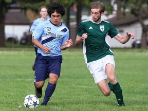 Ethan Quinteros, left, of the Ursuline Lancers battles Owen Ladanchuk of the St. Patrick's Fighting Irish during the LKSSAA 'AAA' senior boys' soccer final at Ursuline College Chatham in Chatham, Ont., on Thursday, May 19, 2022. Mark Malone/Chatham Daily News/Postmedia Network