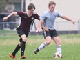 McGregor Panthers' Leo Poenisch, left, chases Wallaceburg Tartans' Ryan Burritt during the LKSSAA 'AA' senior boys' soccer final at John McGregor Secondary School in Chatham, Ont., on Friday, May 20, 2022. Mark Malone/Chatham Daily News/Postmedia Network