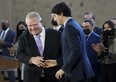 Prime Minister Justin Trudeau, right, shakes hands with Ontario Premier Doug Ford after reaching and agreement in $10-a-day child-care program deal in Brampton, Ont., on Monday, March 28, 2022.