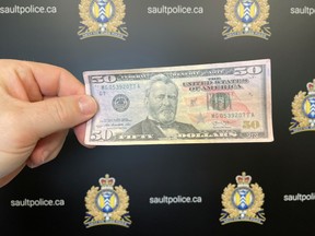 Counterfeit US currency is in the Sault.