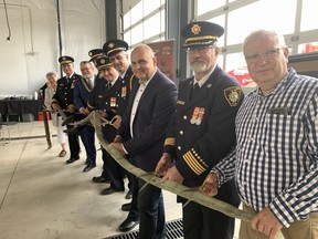 A fire hose is cut on Saturday for the official opening of a new fire hall in Scotland.