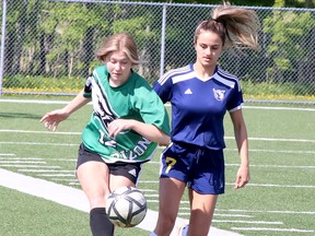 Emily Winsor (12) of the l'Horizon Aigles and Andrea Begic (7) of the Notre Dame Alouettes battle for the ball during the SDSSAA Open Girls Premier soccer final at James Jerome Sports Complex in Sudbury, Ontario on Tuesday, May 24, 2022.