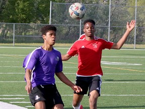 Maliq Olanrewaju (8) of the Lo-Ellen Knights races Kamal Oduwole (14) of the St. Charles Cardinals to a loose ball during the SDSSAA Senior Boys Premier soccer final at James Jerome Sports Complex in Sudbury, Ontario on Tuesday, May 24, 2022.