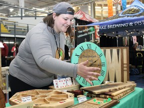 Kallie Williams of Kalex Custom Carvings rolls dice at the spring Fort McMurray Trade Show at MacDonald Island Park on Sunday, May 1, 2022. Vincent McDermott/Fort McMurray Today/Postmedia Network