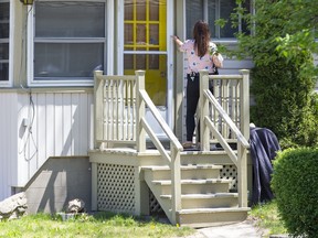 A Lambton County OPP officer knocks on the door of a home as she canvasses a neighbourhood where a 27-year-old Exeter man was fatally stabbed Friday night. Two men and a woman are charged in the homicide. Photo shot on Sunday, May 15, 2022. (Derek Ruttan/The London Free Press)