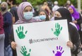 Friends of 15-year-old Yumnah Afzaal, who died when her family was hit by a truck while walking in London in an attack police say was motivated by anti-Muslim hate, hold a sign at a vigil for the family in 2021. Incidents of hate rose after the killing the the Afzaal family, police report. (Mike Hensen/The London Free Press)