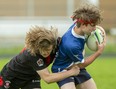 Paul Rutledge of Medway secondary school tackles Riley Therrien of Parkside collegiate institute during a TVRA rugby match at Parkside in St. Thomas on Wednesday, May 18, 2022. (Mike Hensen/The London Free Press)