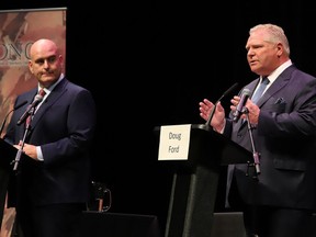 Ontario PC party leader Doug Ford makes a point at the Federation of Northern Ontario Municipalities debate at the Capitol Centre in North Bay, Ont. as Liberal leader Steven Del Duca listens in on Tuesday, May 10, 2022.