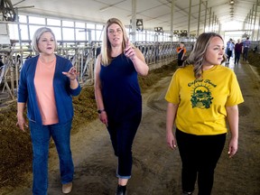Tracey Arts, centre, talks to NDP Leader Andrea Horwath, left, and Oxford NDP candidate Lindsay Wilson at the Arts family farm north of Thamesford on Wednesday, May 11, 2022. Horwath toured the large dairy farm on her first of several campaign stops in Southwestern Ontario. (Mike Hensen/The London Free Press/Postmedia Network)