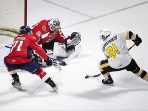 Sarnia Sting’s Max Namestnikov drives to the Windsor Spitfires’ net guarded by goalie Matt Onuska and Josh Currie in Game 5 of their OHL Western Conference quarter-final at the WFCU Centre in Windsor, Ont., on Saturday, April 30, 2022.  (DAX MELMER/Windsor Star)