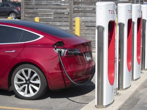 A Tesla car is being charged at the Tesla Supercharger station at King's Cross shopping mall in Kingston, Ontario on Tuesday, July 7, 2020. THE CANADIAN PRESS IMAGES/Lars Hagberg ORG XMIT: LTH308_Tesla