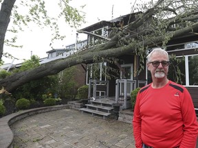 Aftermath of Saturday's storm damage in South Ajax - Pickering Beach area has caused massive damage to properties and shut the power down to the area. (Pictured) A massive tree snapped at the front of Scott Chamberlain's home on Seabreeze Dr. Causing massive dame to the front of his house. on Sunday May 22, 2022. Jack Boland/Toronto Sun/Postmedia Network