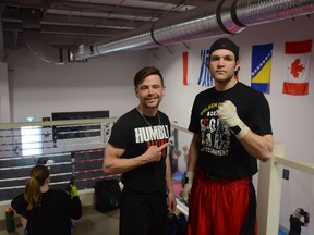 Wade Hodgson, left, and Zach Contos strike a pose in Humble Boxing Academy in Airdrie, the club where they both train. Both were gold medal finallists at the Alberta Golden Gloves event in Edmonton on April 24.  Photo by Riley Cassidy/The Airdrie Echo/Postmedia Network Inc.