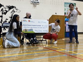 George McDougall students present the Alberta Children's Hospital Foundation with an honourary big checque featuring the cumulitive amount of money raised through the school's Ride of the Mustangs throughout the years. Photo courtesy of the Alberta Children's Hospital Foundation.