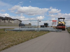 Parts of the sidewalk along 40th Avenue remain closed as construction continues on the interchange. Council passed three debenture bylaws that will allow funds to be borrowed to continue on a number of projects, including two relating to 40th Avenue. Photo by Riley Cassidy/The Airdrie Echo/Postmedia Network Inc.