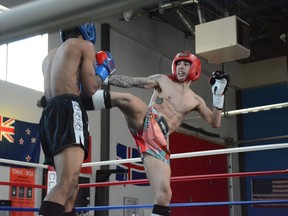 Local athlete Scott Chalupiak lands a kick against Leduc opponent Chamanie Fraser. The Bellagardes Dragon won the 130-lbs. bout at Trial by Fire at the Airdrie Martial Arts Centre on May 28.