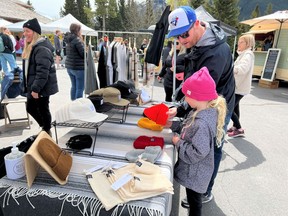 Dan and Charlee check out the kid-sized offerings from apparel brand and vendor Pacific & Moss at the first Banff Farmers’ Market of the year on May 25. Patrick Gibson/Cochrane Times