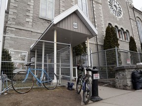 Bicycles and personal items sit outside Belleville's Bridge Street United Church Friday, March 25. The church is still a daytime drop-in centre for people who are homeless but no site has been chosen for next winter's Belleville warming centre.