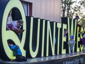 Children play and climb on top of the illuminated Quinte West sign as families enjoy the Victoria Day long weekend festivities Sunday at the Frankford Tourist Park in Quinte West, Ontario. ALEX FILIPE