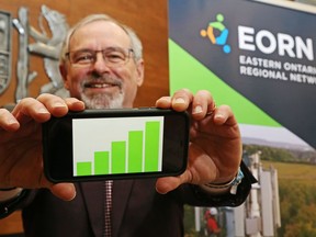 Jim Pine, the Indigenous relations leader for the Eastern Ontario Regional Network, holds his mobile phone March 19, 2021 in Hastings County's council chamber in Belleville. The network's contract with Rogers Communications Inc. is to improve, by 2025, mobile telecommunications service in eastern Ontario.