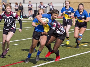 Grace Jacklyn of Brantford Collegiate Institute shakes off a tackle attempt by Simcoe Holy Trinity High School player to score her second consecutive try in the first half of a semifinal match played on Monday in Brantford. 
Brian Thompson