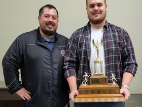 Brantford Track and Field Club coach Sean Doucette presents Josh Linington with The Expositor Trophy. Submitted