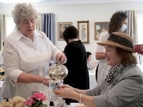 Valerie Hastings serves tea to Jean Emmott during the Langford Community Church Victorian Tea Saturday afternoon.  CHRIS ABBOTT