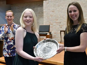 Jade Ondrik (centre) accepts the Richard and Virginia Blaha Memorial Silver Tray, the top prize at the Brant Music Festival, from voice adjudicator Amie Debrone. Looking on is piano adjudicator Geoffrey Conquer.