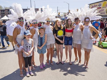 Dressed as Vegas showgirls, The Canadian Country Cruisers pose for a photo with (from left) Rarity Sasseville, Winter Lalonde, Taya and Trinity Sasseville, all of Sudbury who were visiting family in Port Dover and took in the Friday the 13th Gathering. Brian Thompson/Brantford Expositor/Postmedia Network