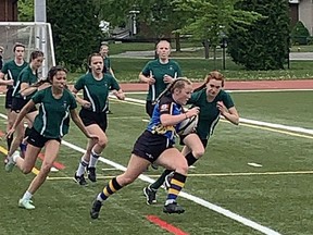 Brantford Collegiate Institute's Sophie Carson eludes a tackle from a Guelph Collegiate Institute player on her way to a try at the Central Western Ontario Secondary Schools Association AAA girls rugby championship at Bisons Alumni North Park Sports Complex on Wednesday. Expositor Photo