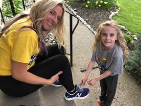 Hope Jennions, 6, helps her mom Abbey Ball with her laces before a training session.  Ball is among 10 Brantford and area residents who will be walking 100 kilometers in 24 hours in support of her daughter and others who live with cystic fibrosis.  VINCENT BALL