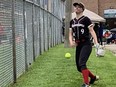 Emily Cox, of the Brantford Warriors, tosses a warm-up pitch before entering a game at the Syl Apps Community Centre on Sunday. The Warriors were one of 89 teams competing in the Queens of the Diamonds Victoria Day Classic on the weekend. VINCENT BALL