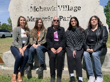 Roberta Hill (centre)  a survivor of the former Mohawk Institute residential school, is joined by her daughters and granddaughters at a commemorative apple tree planting ceremony on Tuesday on the school grounds. Amanda Hill (left), Kalia Kennedy, Sierra General and Carrie General all took part in the ceremony attended by Mark Hill, elected chief of the Six Nations of the Grand River, Stacey Laforme, elected chief of the Mississauga of the Credit First Nation, Brantford Mayor Kevin Davis, Marc Miller, Minister of Crown-Indigenous Relations, and survivors, including Geronimo Henry and Sherlene Bomberry, Vincent Ball