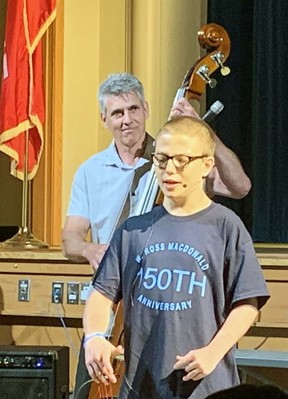Jake Zavitz, a secondary student at W. Ross Macdonald School, sings during a ceremony Thursday celebrating the school's 150th anniversary.  Playing the bass is former staff member Denis Rondeau.  Vincent Ball