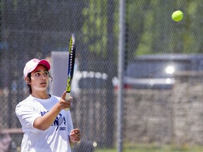 Danakia Parasram of Assumption College returns a serve as she and team-mate Elisa Tchaptchet played in a girls doubles match on Monday May 30, 2022 during the Athletic Association of Brant, Haldimand and Norfolk junior tennis championships at Dufferin Park in Brantford, Ontario.