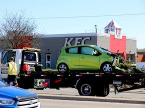 A Brockville Towing employee prepares to take away one of the vehicles involved in a two-vehicle collision on Stewart Boulevard on Monday afternoon. (RONALD ZAJAC/The Recorder and Times)