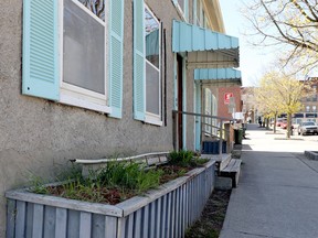 Part of a rain-gutter lies on a flowerbed at one of the Market Street West properties slated for demolition. (RONALD ZAJAC/The Recorder and Times)