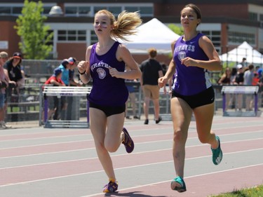 Summer Covey (left) and Tori Morin of TISS complete the first lap of the novice girls 800-metre final at the LGSSAA track and field meet in Brockville on Friday. Covey went on to win in a time of 2:39.72. Morin was second at 2:44.29.
Tim Ruhnke/The Recorder and Times