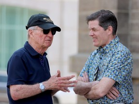 Former senator Bob Runciman, left, speaks to city councillor and mayoral candidate Matt Wren after a rally in front of Brockville's city hall May 21 calling on city council to pause the demolition of a building on Market Street West. (RONALD ZAJAC/The Recorder and Times)