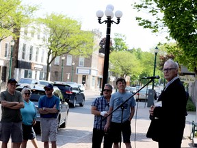 Doug Grant, right, speaks at a rally in front of Brockville's city hall Saturday morning calling on city council to pause the demolition of a building on Market Street West. (RONALD ZAJAC/The Recorder and Times)