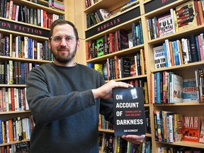 Ian Kennedy holds his new book, On Account of Darkness, inside the Turns & Tales bookstore in downtown Chatham May 10, 2022. Kennedy is also appearing at the store on May 28 for a signing and reading. (Tom Morrison/Chatham This Week)
