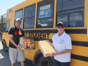 Tim Haskell (left), an organizer of the Fill the Bus campaign to collect food and monetary donations for Chatham Outreach for Hunger, is seen here with Outreach for Hunger executive director Brenda LeClair with some donations collected on May 14. Ellwood Shreve/Postmedia