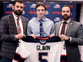 Josh Glavin, centre, of Sarnia, Ont., is welcomed to the Saginaw Spirit by head coach Chris Lazary, left, and general manager Dave Drinkill after signing with the Ontario Hockey League team. He was a third-round pick in the 2022 OHL draft.. (Saginaw Spirit Photo)