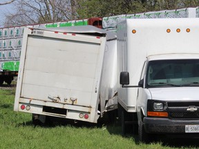 The cube van on the left was damaged when it was struck by a freight train at railway crossing on Colborne Street in Chatham Tuesday afternoon.  The other cube van seen was used to retrieve the contents of the vehicle in the crash.  Ellwood Shreve/Chatham Daily News