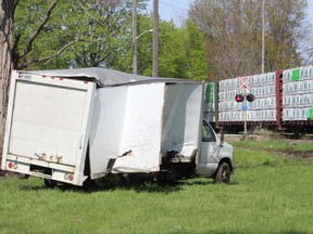 This cube van was damaged when it was struck by a freight train at railway crossing on Colborne Street in Chatham Tuesday afternoon. Witnesses say the impact sent the vehicle spinning into a nearby grassy area. PHOTO Ellwood Shreve/Chatham Daily News