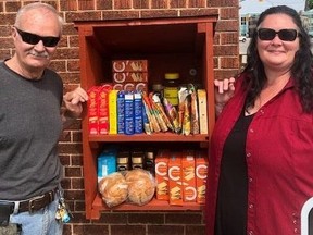 Chatham Hope Have volunteer Gerry Bernard, left, and general manager Loree Bailey display the new Little Free Pantry where people can drop off non-perishable food donations or take food if they need it.