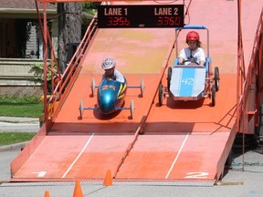 Julia Denijs, 8, left, of Tupperville, and Quinn Martin, 10, of Chatham, were among the many area youth who enjoyed racing the Soapbox Derby during RetroFest in Chatham on Saturday.  PHOTOEllwood Shreve/Chatham Daily News.