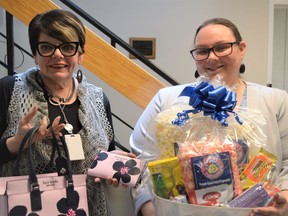 From left, executive director of Maison Baldwin House Debbie Fortier with public educator and volunteer co-ordinator Danielle MacNeil, showing off some of their donated Mother's Day auction items on Wednesday May 4, 2022 in Cornwall, Ont. Shawna O'Neill/Cornwall Standard-Freeholder/Postmedia Network