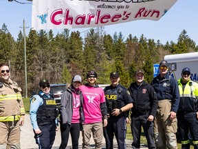 Emergency Services workers at Charlee's Run with organizers Mallory and Dave Holmes (wearing pink). Handout/Cornwall Standard-Freeholder/Postmedia Network